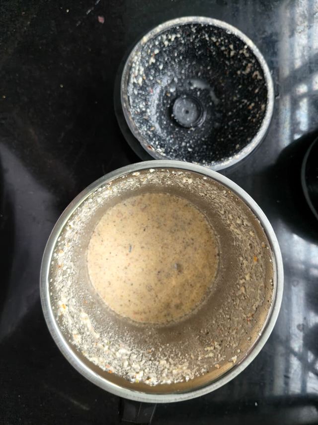 Two small mixer jars on a countertop, one holding a pale, well-blended paneer paste.